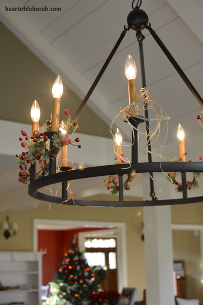Simple and affordable Christmas decorations. Add mini candle wreaths to light fixture!
